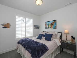 Carpeted bedroom featuring baseboards