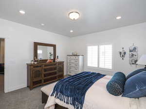 Primary bedroom featuring baseboards and recessed lighting