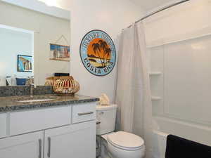 Full bathroom featuring vanity, toilet, and shower / bath combo with shower curtain