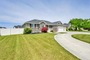 Ranch-style house with stone siding, a garage, and concrete driveway