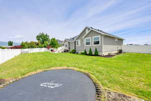 Rear view of property with stucco siding and central AC
