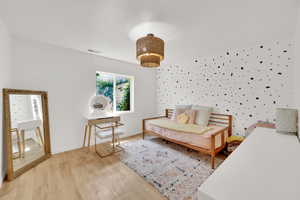 Bedroom with light wood finished floors and baseboards