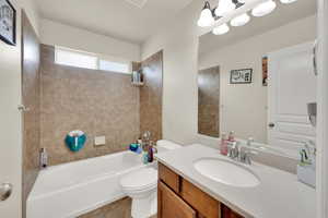 Full bath with vanity, toilet, and shower / tub combination