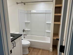 Full bathroom featuring vanity, bathtub / shower combination, and wood finished floors