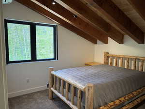 Carpeted bedroom featuring baseboards