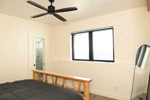 Bedroom with carpet, baseboards, and a ceiling fan