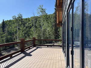 Deck featuring a wooded view