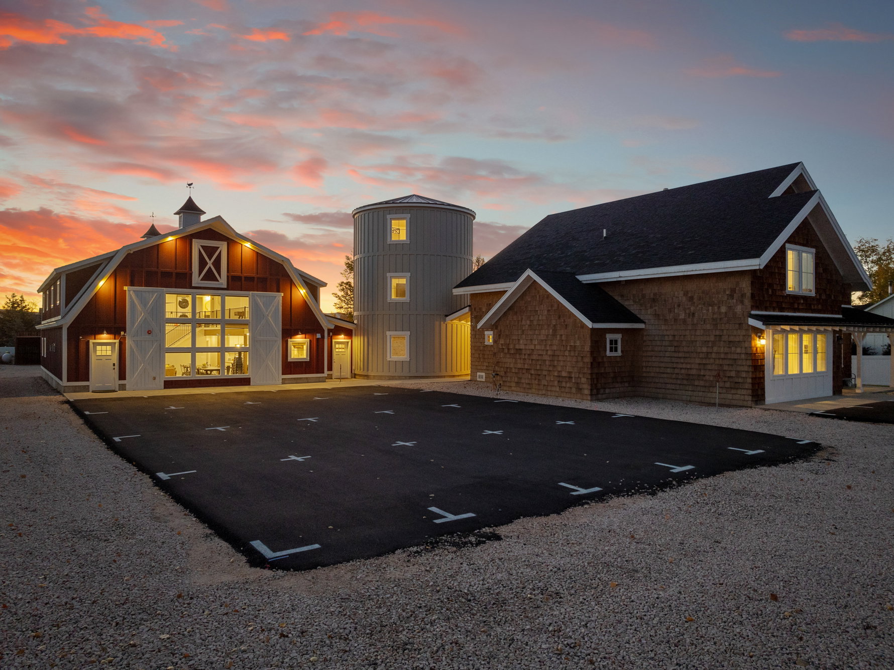 Back of property featuring a barn, uncovered parking, an outdoor structure, and a shingled roof