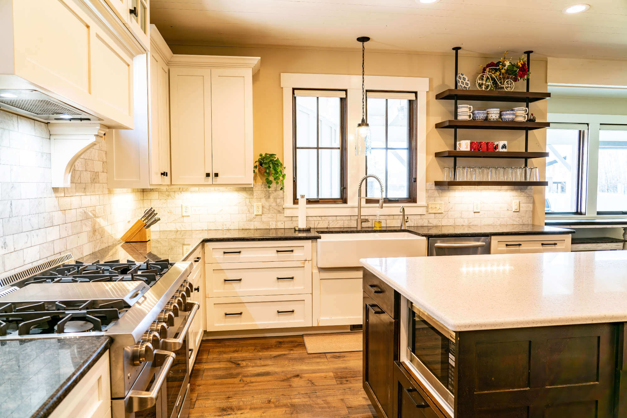 Kitchen featuring stainless steel appliances, a sink, recessed lighting, dark stone counters, and decorative backsplash