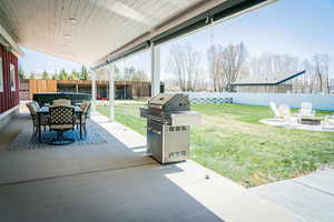 View of patio / terrace with grilling area, an outdoor fire pit, and outdoor dining space