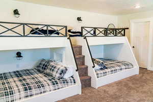 Carpeted bedroom with a textured ceiling