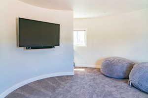 Sitting room featuring carpet and baseboards