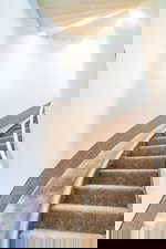 Stairway featuring beam ceiling