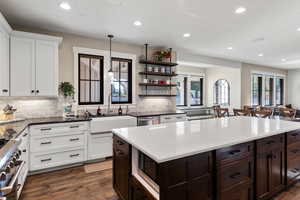 Kitchen featuring recessed lighting, a sink, dark brown cabinetry, appliances with stainless steel finishes, and backsplash