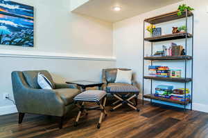 Living area with wood finished floors, baseboards, and recessed lighting