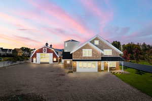 View of front of property featuring driveway, a standing seam roof, and metal roof