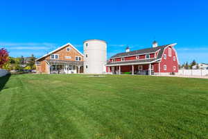 Rear view of property with a chimney and a gambrel roof