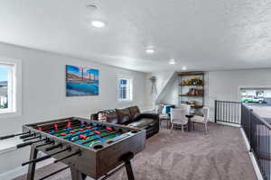 Rec room featuring carpet, a textured ceiling, and recessed lighting