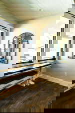 Unfurnished room with baseboards and dark wood-style flooring