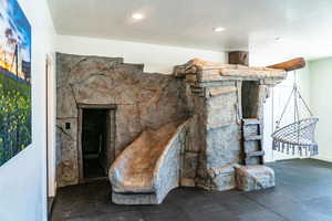 Living area featuring a textured ceiling and recessed lighting
