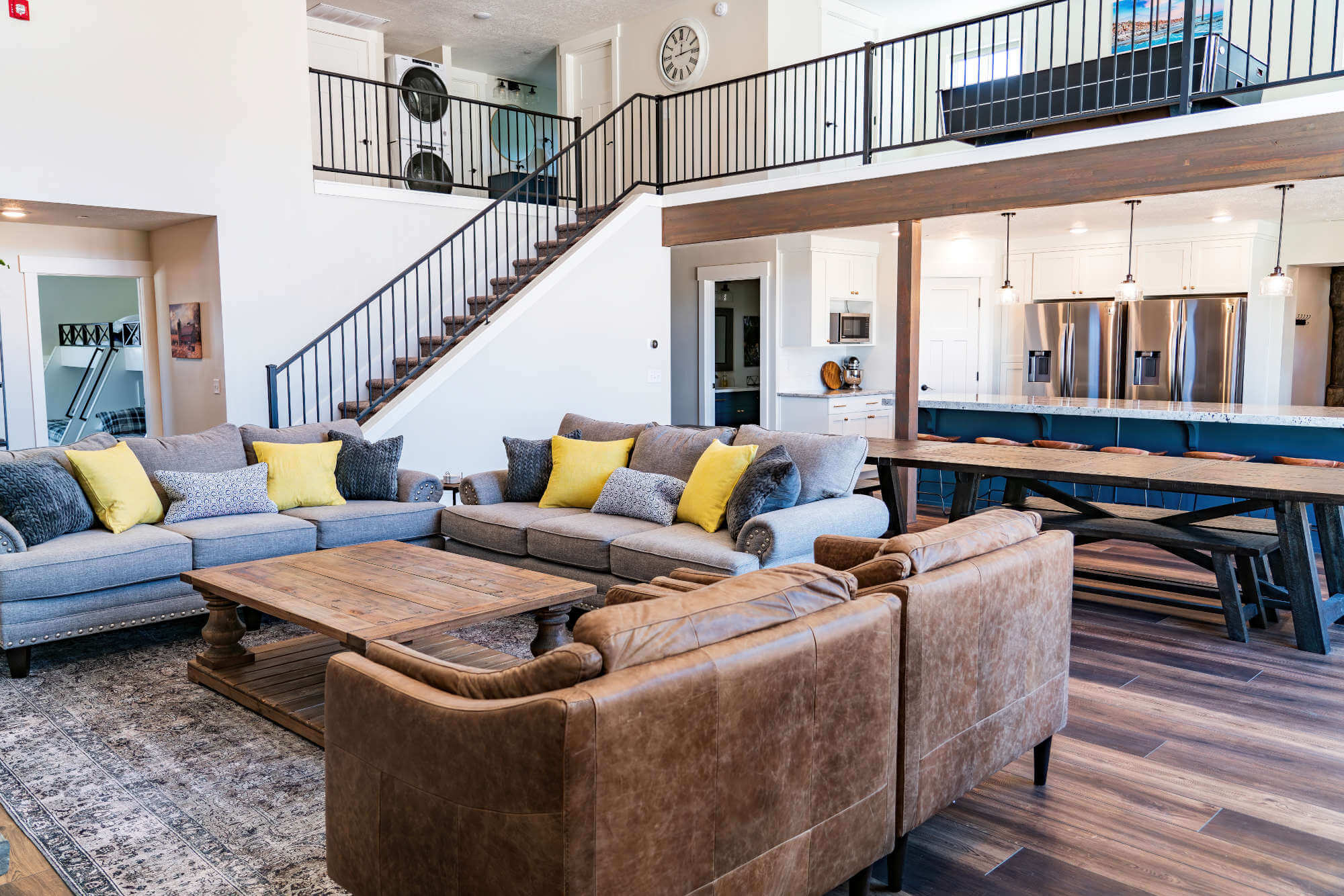 Living area featuring a towering ceiling, stairs, and dark wood finished floors