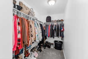 Spacious closet with carpet flooring