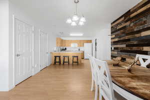 Dining room featuring light wood-style floors and a chandelier