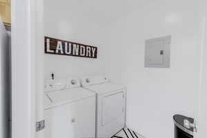 Laundry area with electric panel and independent washer and dryer