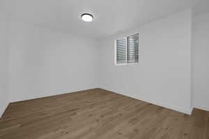Unfurnished room with light wood-style flooring and baseboards