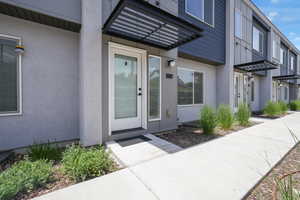 Property entrance with stucco siding