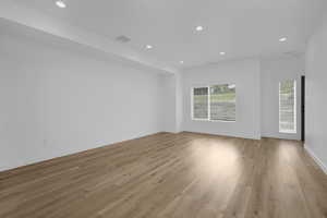Empty room featuring recessed lighting, light wood finished floors, and baseboards