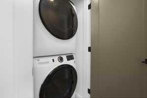 Laundry room featuring stacked washer / drying machine