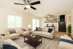 Living room with stairs, a ceiling fan, and light carpet virtually staged