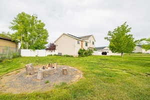 View of yard featuring an outdoor fire pit and central AC