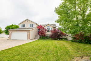 View of front of house featuring driveway, a garage, and brick siding