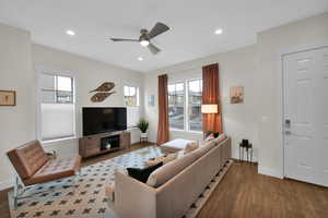Living room featuring wood finished floors, ceiling fan, baseboards, plenty of natural light, and recessed lighting