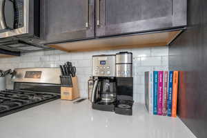 Kitchen with stainless steel appliances and backsplash