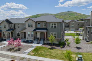 View of front facade with board and batten siding, a residential view, a mountain view, and stone siding