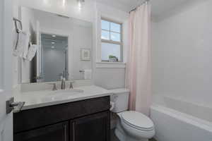 Full bathroom with vanity, toilet, and shower / tub combo