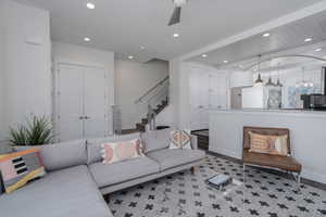 Living area featuring recessed lighting, stairway, ceiling fan, light wood finished floors, and baseboards