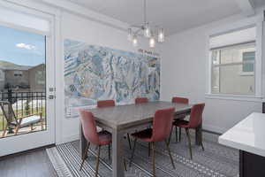 Dining room featuring wood finished floors, baseboards, and beamed ceiling