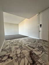 Empty room with marble finish floors and baseboards
