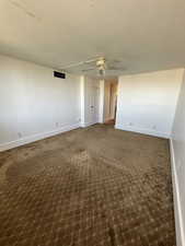 Spacious Primary bedroom featuring a ceiling fan, carpet floors and new paint