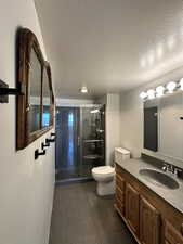 Guest 3/4 bath with vanity, shower, and tile flooring