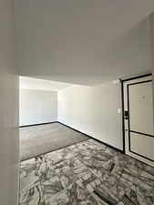 Entry  with marble finish tile flooring and baseboards