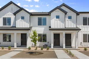 Modern inspired farmhouse with covered porch, board and batten siding, central AC, and roof with shingles
