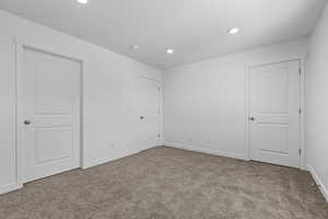 Unfurnished bedroom featuring carpet flooring, recessed lighting, and baseboards