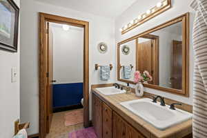 Bathroom featuring double vanity and toilet