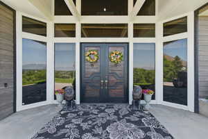 View of exterior entry featuring french doors
