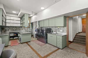 Washroom featuring washing machine and clothes dryer and recessed lighting